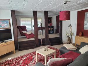 a living room with a couch and a tv at Wohnung Waltraud in Plattenburg