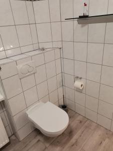 a bathroom with a white toilet and a roll of toilet paper at Im Harzer Vogelnest Spatzennest in Bad Harzburg