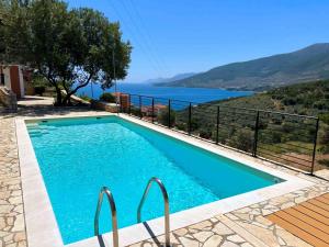 a swimming pool with a view of the water at Villa Galini in Astros
