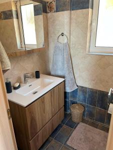 a bathroom with a sink and a mirror at Villa Galini in Astros