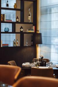 a restaurant with tables and chairs and a window at AMERON Köln Hotel Regent in Cologne