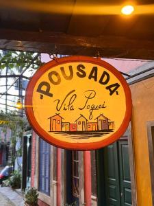 a yellow sign for a uitzaqilla tavern at Vila Pequeá Ilhabela in Ilhabela