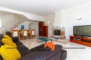 a living room with a couch and a tv at #248 Villa Loureira 54 by Home Holidays in Albufeira