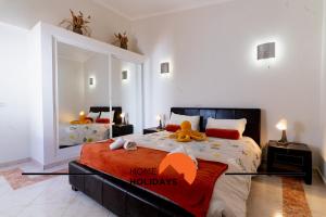 a bedroom with a large bed with a large mirror at #248 Villa Loureira 54 by Home Holidays in Albufeira