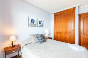 a bedroom with a bed and a wooden door at Primera linea de playa in La Manga del Mar Menor +14 photos