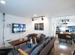 a dog sitting on a couch in a living room at 2 Bedrooms 1 living room near Old City in Chiang Mai