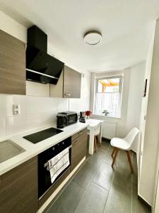 a kitchen with a sink and a stove at Stendaler Apartments in Stendal +12 photos