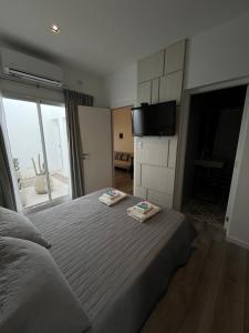a bedroom with a bed with two towels on it at Macarena in La Rioja