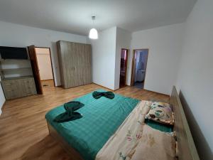 a bedroom with a large bed in a room at Varipatti House in Slatina