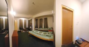 a bedroom with a large bed in a room at Dolma's Homestay in Phensāng