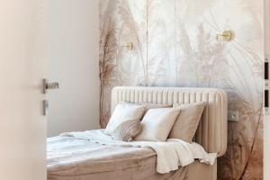 a bedroom with a bed with pillows on it at Apartamenty Garbarska in Lublin