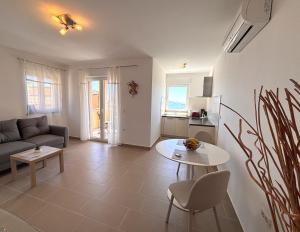 a living room with a couch and a table at Apartments Quarnero Rabac in Rabac