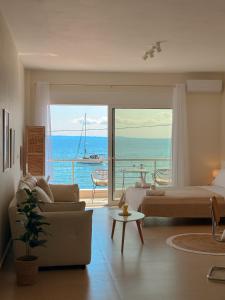 a bedroom with a bed and a view of the ocean at Above The Sea Luxury Apartment in Nikiti