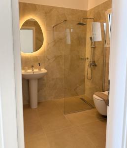 a bathroom with a glass shower and a sink at Above The Sea Luxury Apartment in Nikiti +14 photos