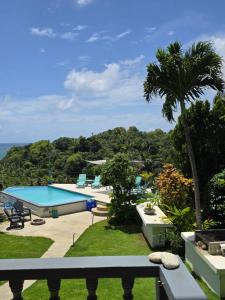 a view of a swimming pool from a resort at Hodges Bay House in Calibishie