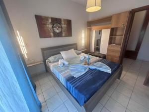 a bedroom with a bed with towels on it at Dimitra Apartments in Keramoti