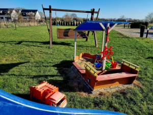 a playground with a play set in the grass at PRZYSTAŃ CISZY in Jantar