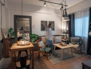 a woman is standing in a living room at 2 Bedrooms 1 living room near Old City in Chiang Mai