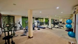 a gym with lots of treadmills and exercise bikes at Deva Beach Resort Samui in Choeng Mon Beach