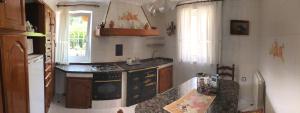 a kitchen with a sink and a stove top oven at La casa de Cudón in Cudón