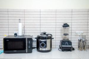 a microwave and a blender on a kitchen counter at Oasis Homestay in Arusha
