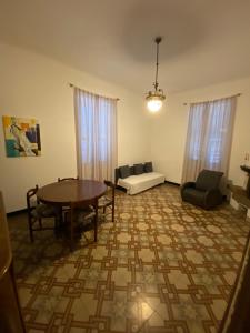 a living room with a table and chairs at Otasso Finalpia in Finale Ligure