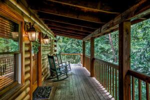 - une véranda avec 2 chaises dans l'établissement Nice View Fireplace, Hot Tub, Porch Bed, Private, à Sevierville