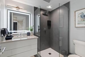 a bathroom with a shower and a toilet and a sink at Ammos Luxury Living- Naxos Suite in Ventnor City
