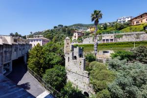 a view of a castle with trees and buildings at Pathway To The Sea in Pieve Ligure