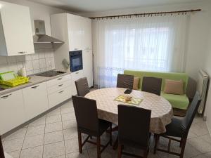 a kitchen and dining room with a table and chairs at Apartment Viškovo in Viskovo