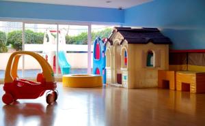a room with a toy car and a play house at The Mercer Sukhumvit 4 in Bangkok