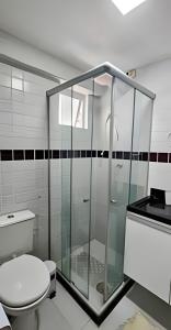 a glass shower in a bathroom with a toilet at Vista Mar Bessa, 100m da orla, 1 dorm. e garagem in Nossa Senhora do Livramento +14 photos