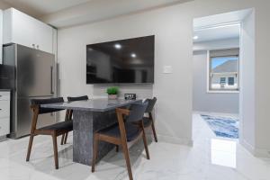 a kitchen with a table and chairs and a refrigerator at Ammos Luxury Living- Paros Suite in Ventnor City +27 photos