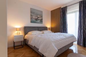 a bedroom with a large bed and a window at NEW! Apartment in Petrčane 30 meters from the sea - TA Leut Agency in Petrcane