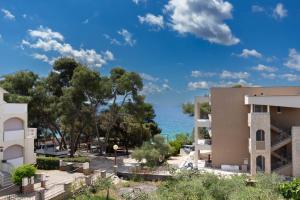 a view of a building and the ocean at NEW! Apartment in Petrčane 30 meters from the sea - TA Leut Agency in Petrcane