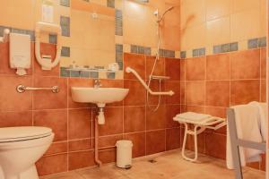 a bathroom with a toilet and a sink at Hôtel Édenia - Spa Estime&Sens in Carnac +73 photos