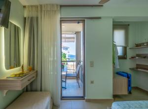 a bedroom with a door leading to a balcony at Marthina Luxury Living in Nea Potidaea