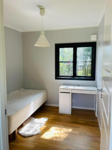 a small bedroom with a bed and a window at 3-Bedroom Charming Lund Home in Lund