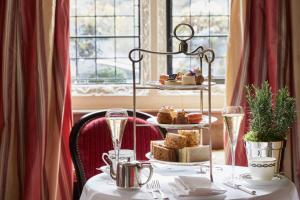 a table with a plate of food on top at Milestone Hotel Kensington in London