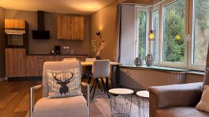 a kitchen and living room with a table and chairs at Harz hotel Iris in Herzberg am Harz
