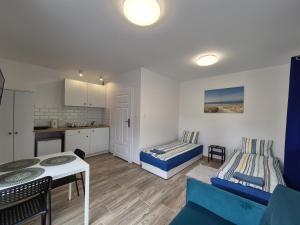 a small living room with a couch and a table at Domek w Parku Hel in Hel