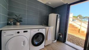 a laundry room with a washing machine and a refrigerator at Villa des Embruns Entre Hossegor et Biarritz in Boucau