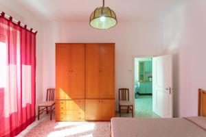 a bedroom with a closet and a red curtain at Villetta Giovanna a 50m dal mare - Salento Reservation in Marina di Mancaversa