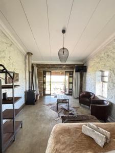 a living room with a bed and a couch at La Vista Farm Stay in Ermelo