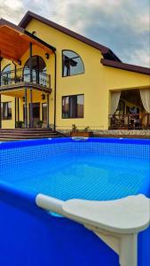 a swimming pool in front of a house at Villa Vermont Qusar in Qusar