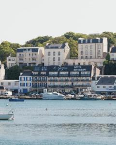 a harbor with boats in the water and buildings at Maison LE GOYEN & Spa in Audierne
