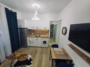a kitchen and dining room with a table and a table and a kitchen at Amo Apartment in Tirana