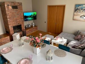 a living room with a white table with flowers on it at Kunderi apartment with sauna in Rakvere