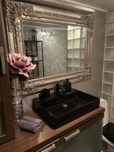a bathroom with a black sink and a mirror at Kunderi apartment with sauna in Rakvere +14 photos