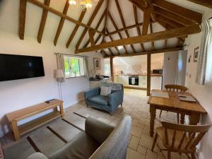 a living room with a couch and a table at Acorns in Plaitford